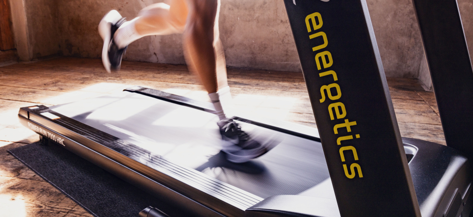Eine Person, die auf einem Laufband der Marke Energetics für Indoor-Cardio-Training und Fitnesstraining läuft.